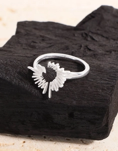 Macro detail of S925 sterling silver ring with irregular radiant sunburst texture
