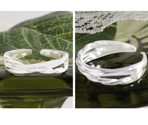 Macro shot of S925 sterling silver stamp and twisted irregular cross wrap ring detail