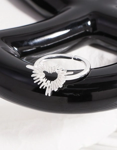 Macro detail of S925 sterling silver irregular heart ring with radial sunburst design