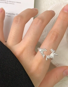 Macro shot of silver irregular starburst heart ring with adjustable open band detail
