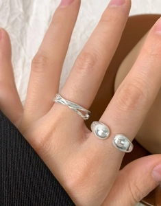 Detail showing S925 engraving on irregular entwined and ball-end silver rings