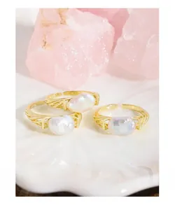 Detail of S925 sterling silver gold-plated ring featuring a baroque pearl with cable texture