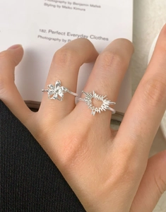Detail of S925 sterling silver ring set featuring heart and sunburst floral designs