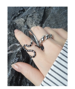 Detail of S925 silver snake ring with black enamel stripes and twisted band on model