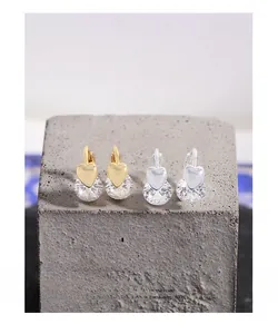 Vue détaillée des boucles d'oreilles cœur en or et argent avec cristaux de zircone