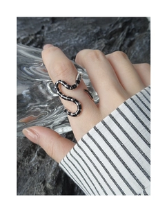 Detail of S925 sterling silver snake ring with black enamel stripes on a model
