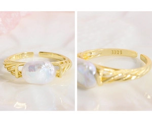 Macro shot of S925 sterling silver stamp and baroque pearl on the twisted ring band