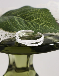 Detail of S925 sterling silver stamp on the irregular woven texture of the ring
