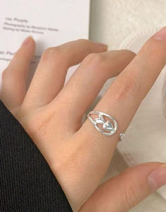 Close-up of adjustable silver S925 ring featuring a double heart cutout design on finger
