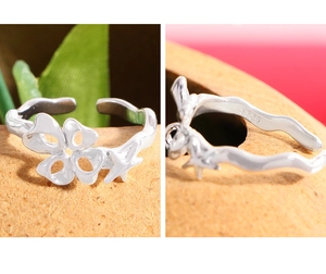 Detailed macro view of S925 sterling silver ring with starfish and flower design
