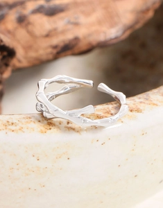 Macro shot of S925 sterling silver cross bamboo texture ring with adjustable opening