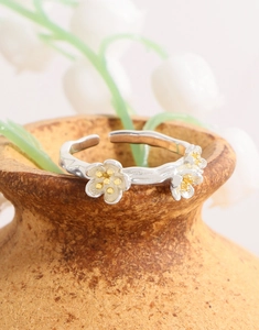 Detail of S925 silver flower ring with gold stamens and textured branch band