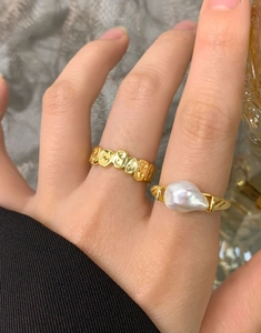 Detail of S925 silver ring featuring an irregular baroque pearl with wavy golden texture
