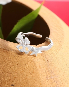 Detail of S925 sterling silver ring featuring a star element on a clay pottery surface