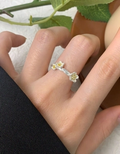 Detailed close-up of S925 silver flower ring with white enamel petals and twig texture