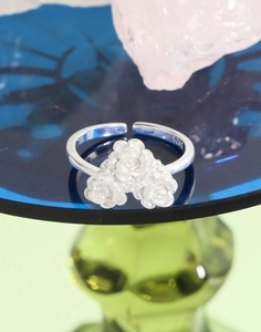 Detailed macro view of S925 sterling silver ring with three blooming rose flowers clusters