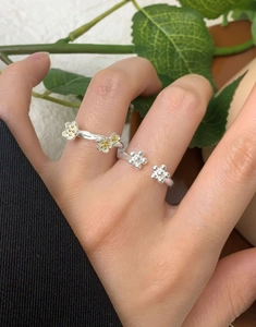 Macro detail of S925 sterling silver petal ring with gold-plated accents on hand