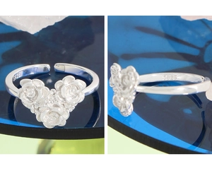 Detailed macro view of S925 sterling silver triple rose floral relief on an open ring