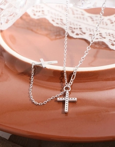 Close-up of S925 sterling silver cross necklace with sparkling cubic zirconia stones
