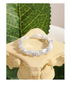 Macro detail of S925 silver twisted ring with zircon on an elegant stone pedestal