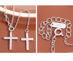 Detailed view of S925 sterling silver lobster clasp with hallmark and zircon cross pendant