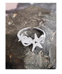 Detail of S925 sterling silver ring showing hollow heart and starfish engraving marks