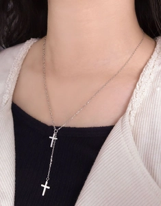 Detail of S925 silver Y-shaped lariat necklace with zircon pavé double cross pendants