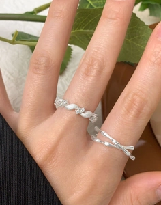 Detail view of double S925 silver rings with twisted brushed texture and zircon accents