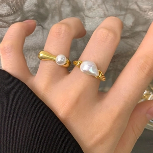 Baroque irregular pearl ring set in S925 sterling silver for women on a grey background