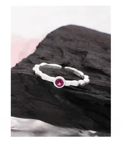 Macro shot of S925 sterling silver bamboo texture ring with a pink zircon stone