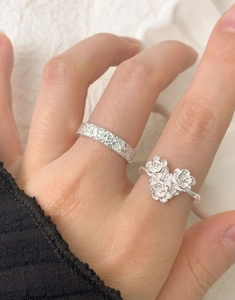 Detailed close-up of S925 sterling silver rings with rose relief and textured band