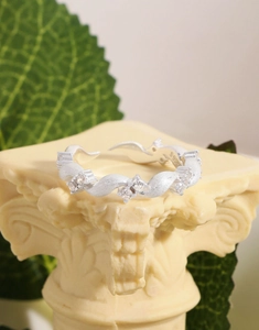 Detailed macro shot of twisted S925 sterling silver ring with sparkling zircon stones