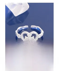 Macro detail of S925 sterling silver hammered heart ring with a hollow cross design
