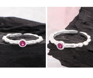Detailed close-up of S925 sterling silver ring with bamboo texture and red zircon gem