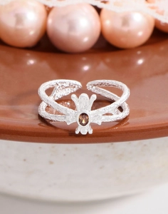Detail of S925 silver ring with hammered texture and oval brown zircon stone