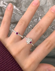 Close-up of S925 silver rings with fuchsia zircon in snowflake and minimalist round design