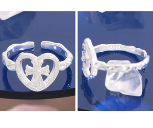 Detailed view of S925 sterling silver heart ring with cross and textured band details