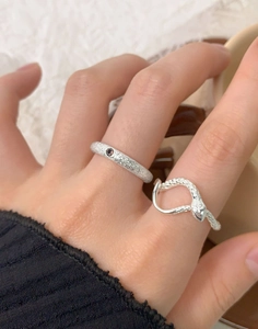 Close-up of S925 silver snake ring and matte gem band on model finger