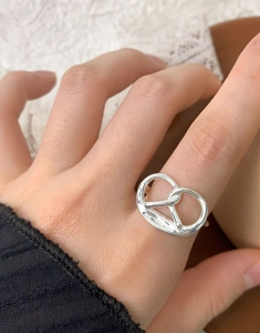 Close-up of S925 sterling silver pretzel knot ring on hand with polished finish