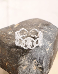 Detailed close-up of S925 sterling silver hammered texture heart ring on natural stone