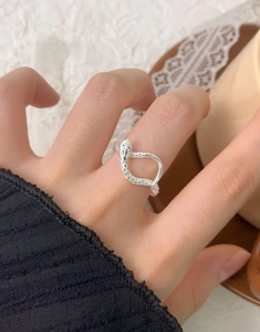 Detail shot of a silver S925 snake ring featuring textured scales and wrap design