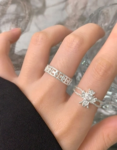Detail of S925 silver rings with hammered texture and heart shaped zircon stone