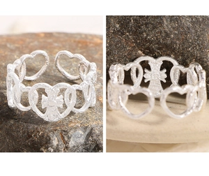 Detailed close-up of S925 sterling silver heart ring with hammered texture and cross