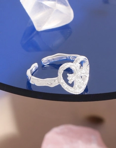 Detail of S925 sterling silver heart ring with hammer texture and inner cross design