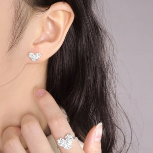 Silver S925 heart ring with rose flower relief design on a female model hand
