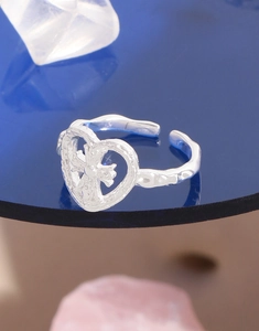 Macro detail of S925 silver ring featuring a hollow heart and inner cross design
