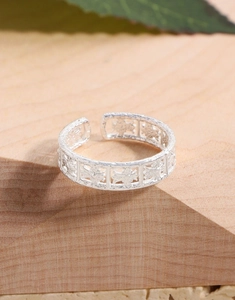 Macro shot of S925 sterling silver hammered texture open ring on rustic wood background