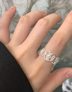 Detail of S925 sterling silver heart ring with gothic cross star pattern worn on index finger