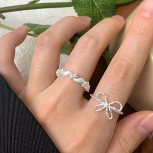 S925 sterling silver bow and twisted zircon rings worn on female hand