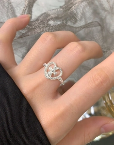 Macro shot of S925 sterling silver hammered heart ring on model hand with retro details